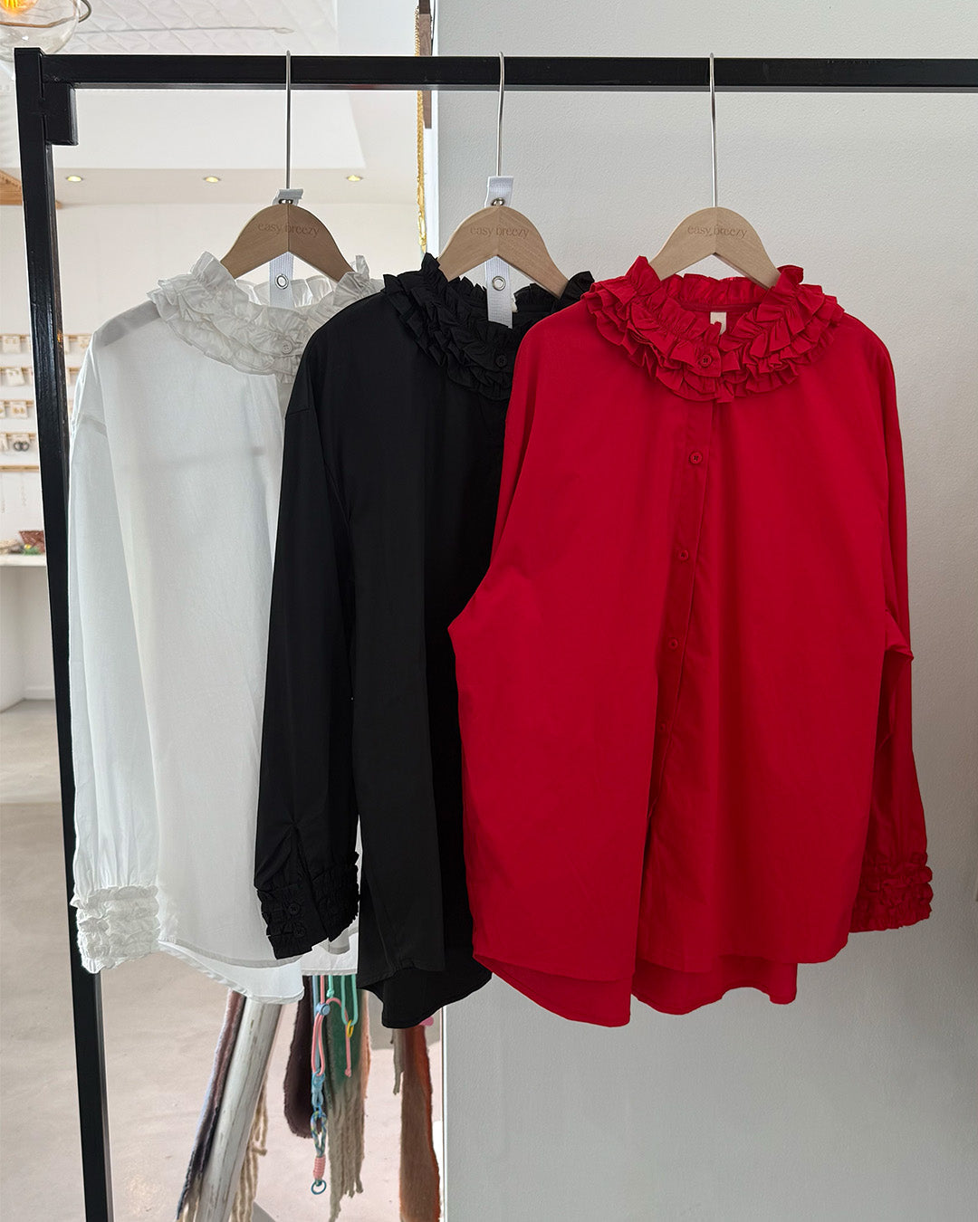 Elegant blouse with ruffled neckline and cuffs